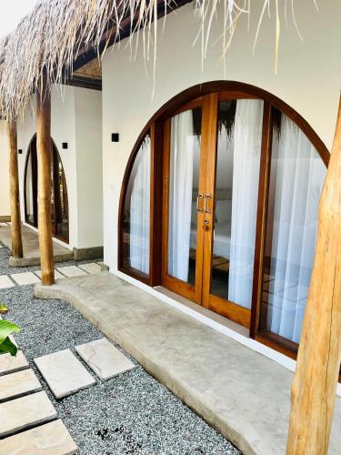 a entrance to a house with wooden doors at Villa Mila - Gili Air in Gili Air