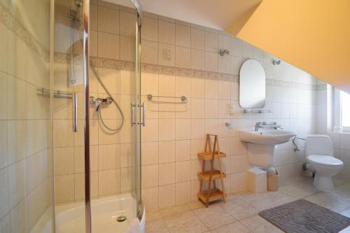 a bathroom with a shower and a sink and a toilet at Villa del Marco in Rewal