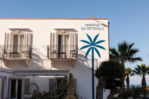a building with a sign for marina de barbosa at Marina di Petrolo Hotel & SPA in Castellammare del Golfo