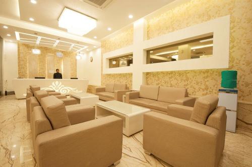 a waiting room with couches and tables and a man at Hotel Le Roi,Haridwar@Har Ki Pauri in Haridwār