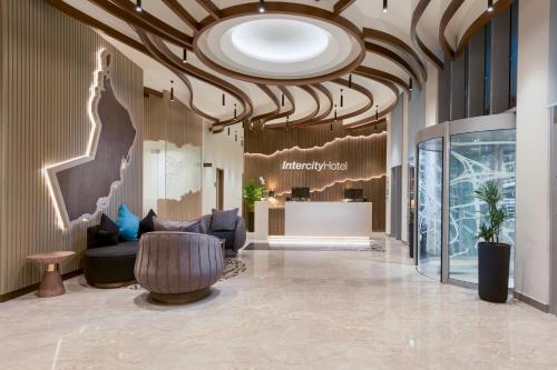a lobby of a store with a large ceiling at IntercityHotel Bawshar Muscat in Muscat