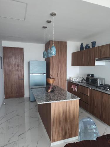 a kitchen with wooden cabinets and a counter top at Sol y mar in Boca del Río