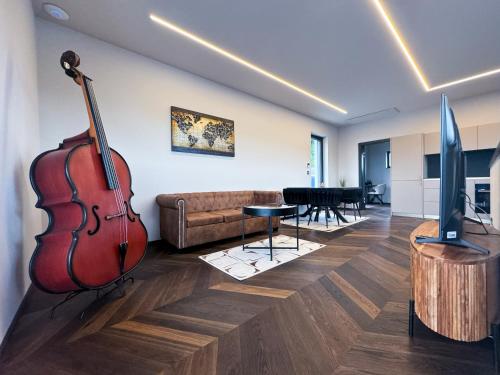 a living room with a violin and a couch at LUXUS-PENTHOUSE mit Weitblick über Graz in Graz