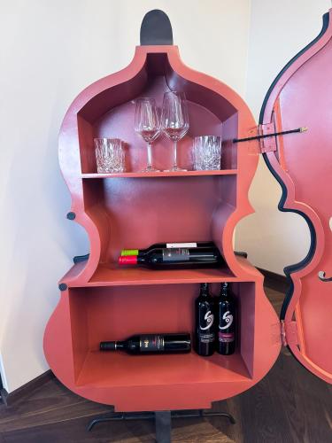 a wine rack with glasses and wine bottles on it at LUXUS-PENTHOUSE mit Weitblick über Graz in Graz