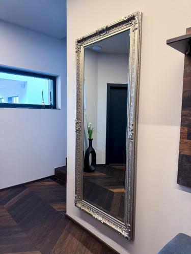 a mirror hanging on a wall in a room at LUXUS-PENTHOUSE mit Weitblick über Graz in Graz