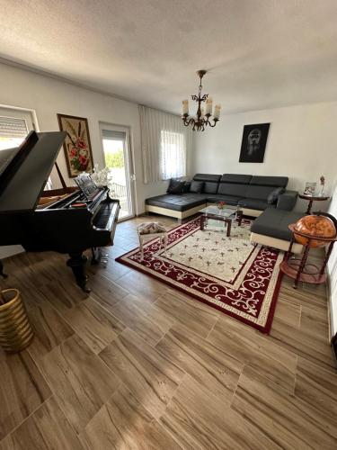 a living room with a couch and a piano at Barok in Tešanj