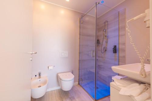a bathroom with a shower and a toilet and a sink at Marina di Petrolo Hotel & SPA in Castellammare del Golfo