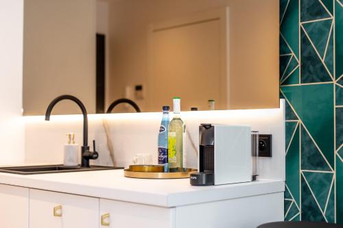 a kitchen counter with a sink and a mirror at Super-Apartamenty VIP Jacuzzi III in Poznań
