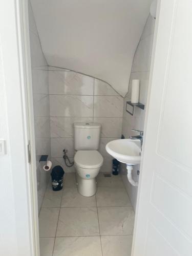 a small bathroom with a toilet and a sink at Azra evleri in Datca