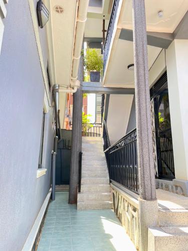 a stairway leading up to a building with columns at K Kitende Apartments in Kampala