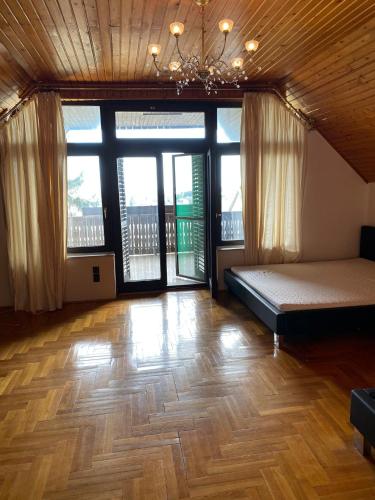 a large room with two beds and large windows at Luxury 3 BR Vila in a forest 10min drive from city center in Budapest
