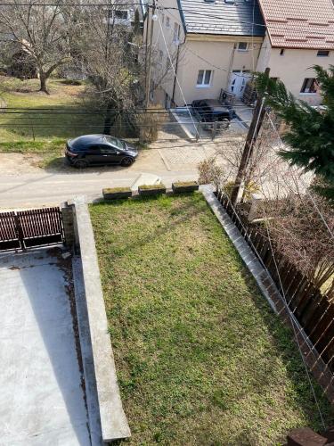 a yard with a car parked in a driveway at Luxury 3 BR Vila in a forest 10min drive from city center in Budapest