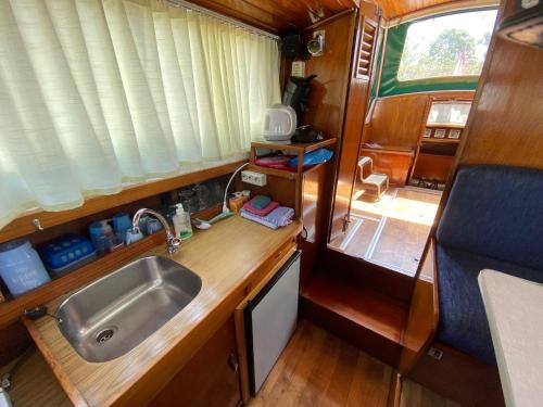 a kitchen with a sink and a counter top at Boat Albatros - kamperen op het water - niet om mee te varen - read host profile-lees hostprofiel in Jutrijp
