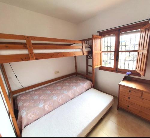 a bedroom with two bunk beds and two windows at LagoVista45 in Torrevieja