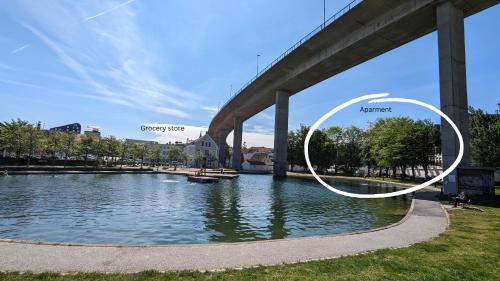 un puente sobre un río con las palabras "ciudad ladrona y bosque" en Kjekk urban leilighet, en Stavanger