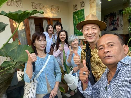 a group of people giving the thumbs up at Suryadina Guest House in Ubud