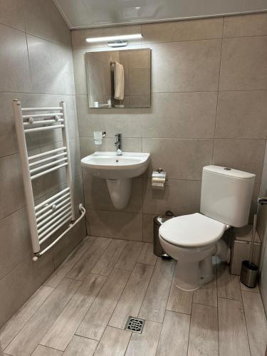 a bathroom with a toilet and a sink at Sunny House in Madzhare