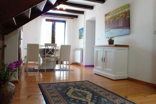 a living room with a table and chairs and a rug at Villa Dina in Tar