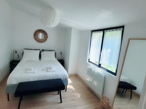 une chambre avec un grand lit et un miroir dans l'établissement Maison de ville au calme avec jardin et parking, à La Rochelle