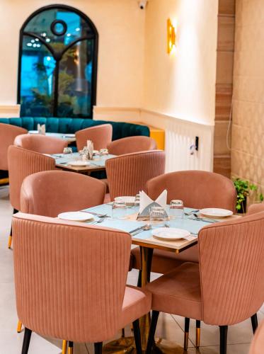 a dining room with tables and chairs and a window at Playsales Scarlet Vijay Nagar Indore in Indore
