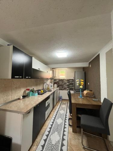 a kitchen with a table and a dining room at Villa Dzeno Sarajevo in Krivoglavci