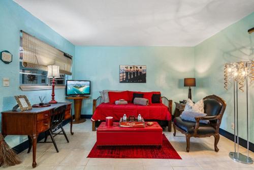 a bedroom with a bed and a desk and a tv at Blue Bell Apartment Hotel in Fort Lauderdale