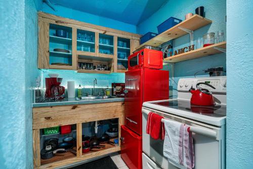 a red refrigerator in a kitchen with a sink at Blue Bell Apartment Hotel in Fort Lauderdale