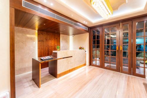 a lobby with a reception desk and glass doors at Playsales Scarlet Vijay Nagar Indore in Indore
