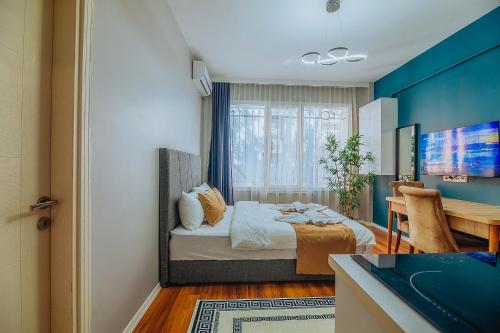a bedroom with a bed and a table in a room at Taksim Wonder Suites in Istanbul