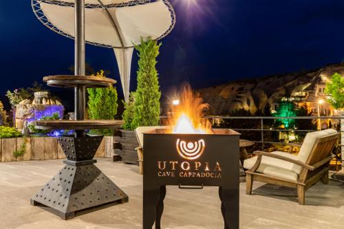 a sign on a patio with a fire pit at Utopia Cave Cappadocia in Urgup