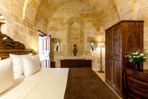 a bedroom with a large white bed in a room at Utopia Cave Cappadocia in Urgup