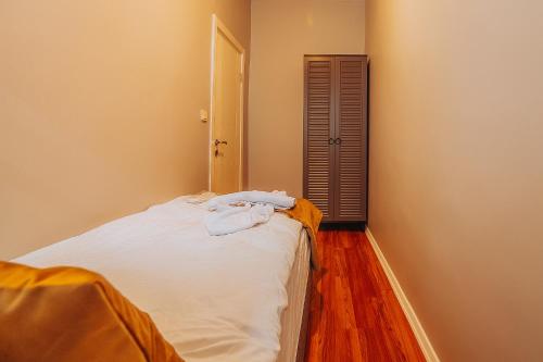 a bedroom with a bed with white sheets and a mirror at Taksim Wonder Suites in Istanbul