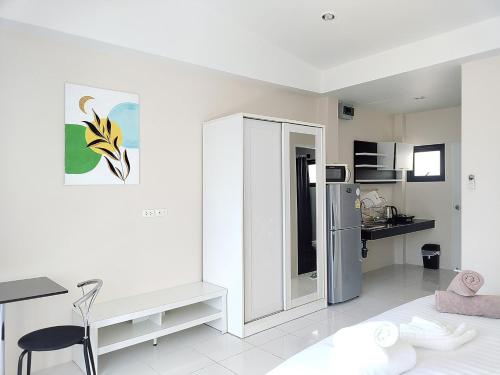 a white living room with a table and a refrigerator at Villa LunaSole Samui in Koh Samui 