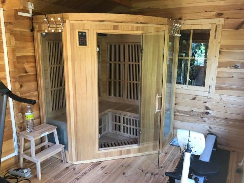 a wooden cabin with a bird cage in it at Villa Les Cedres in Aix-en-Provence