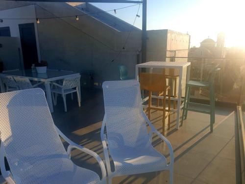 a balcony with two chairs and a table and a table at PROTEA RESIDENCE with private terrace in Nicosia