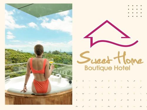 a woman sitting in a bath tub with a glass of wine at Sweet Home Boutique Hotel in Tagbilaran City