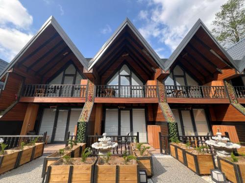 an exterior view of a house with a balcony at Aquarium BUNGALOW UZUNGÖL in Uzungöl