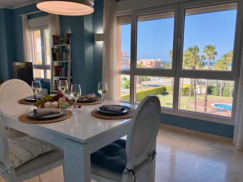 a dining room table with two glasses of wine at BRISA DEL MAR - 200m to the beach in Oliva
