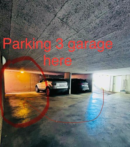 a parking garage with a car parked in it at Lakefront View Entire Apartment with 2 bedrooms, 2 full bathrooms & Balcony Waterview in Reichenau