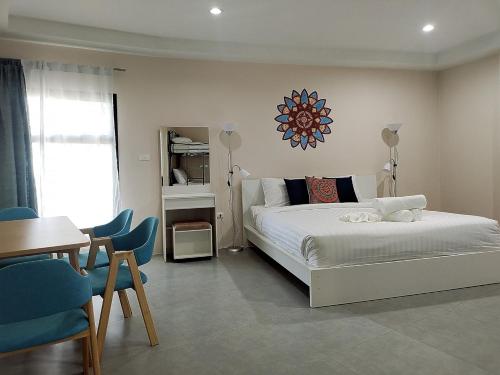 a bedroom with a bed and a table and chairs at Villa LunaSole Samui in Koh Samui 