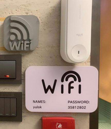 a wii sign on a wall with a wii controller at 榆樂旅館 YULOK Guesthouse in Hong Kong