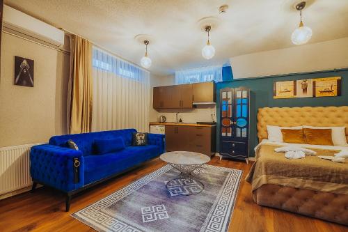 a living room with a blue couch and a bed at Taksim Wonder Suites in Istanbul