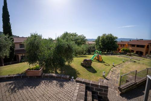 a park with a playground with a slide at Borgo Etrusco in Scarlino