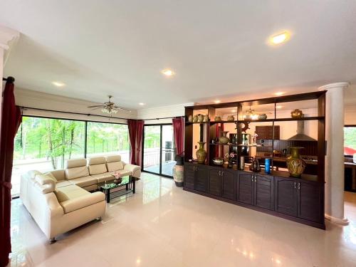 a large living room with a couch and a table at Grand Villa Khaolak in Khao Lak