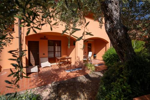a patio of a house with a table and chairs at Borgo Etrusco in Scarlino
