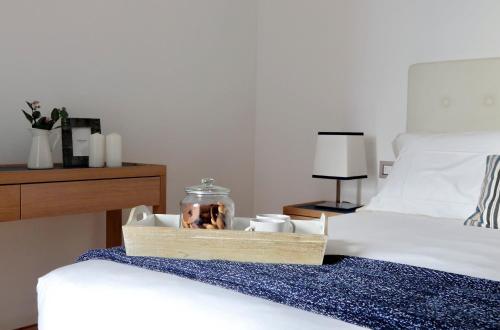 a tray with a picture of a dog on a bed at Portopiccolo Apartments in Sistiana