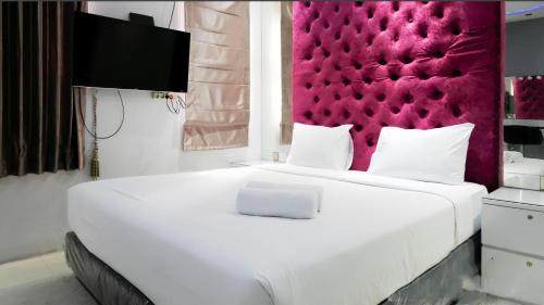 Ένα ή περισσότερα κρεβάτια σε δωμάτιο στο Surabaya Apartment