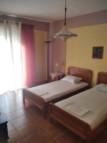 a bedroom with two beds and a window at Thomas Vrasna Close To The Sea in Nea Vrasna
