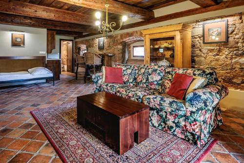 a living room with a couch and a table at Barokni Spejchar in Tlučná