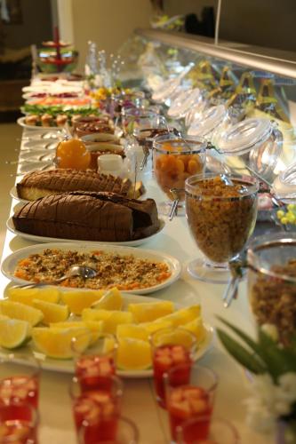 a buffet with many plates of food on a table at Portaluna Hotel & Resort in Jounieh